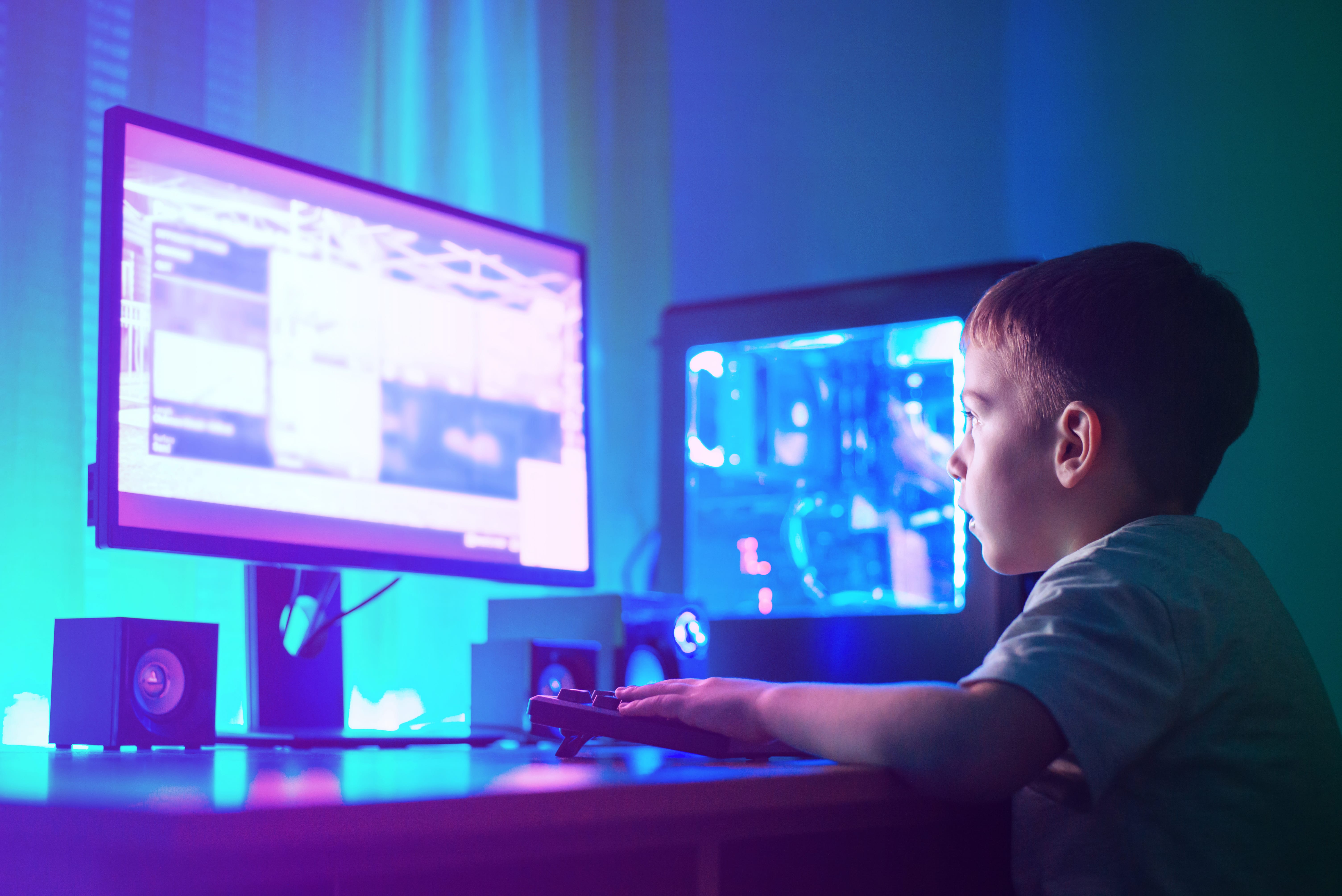 Child with 2 laptop screens