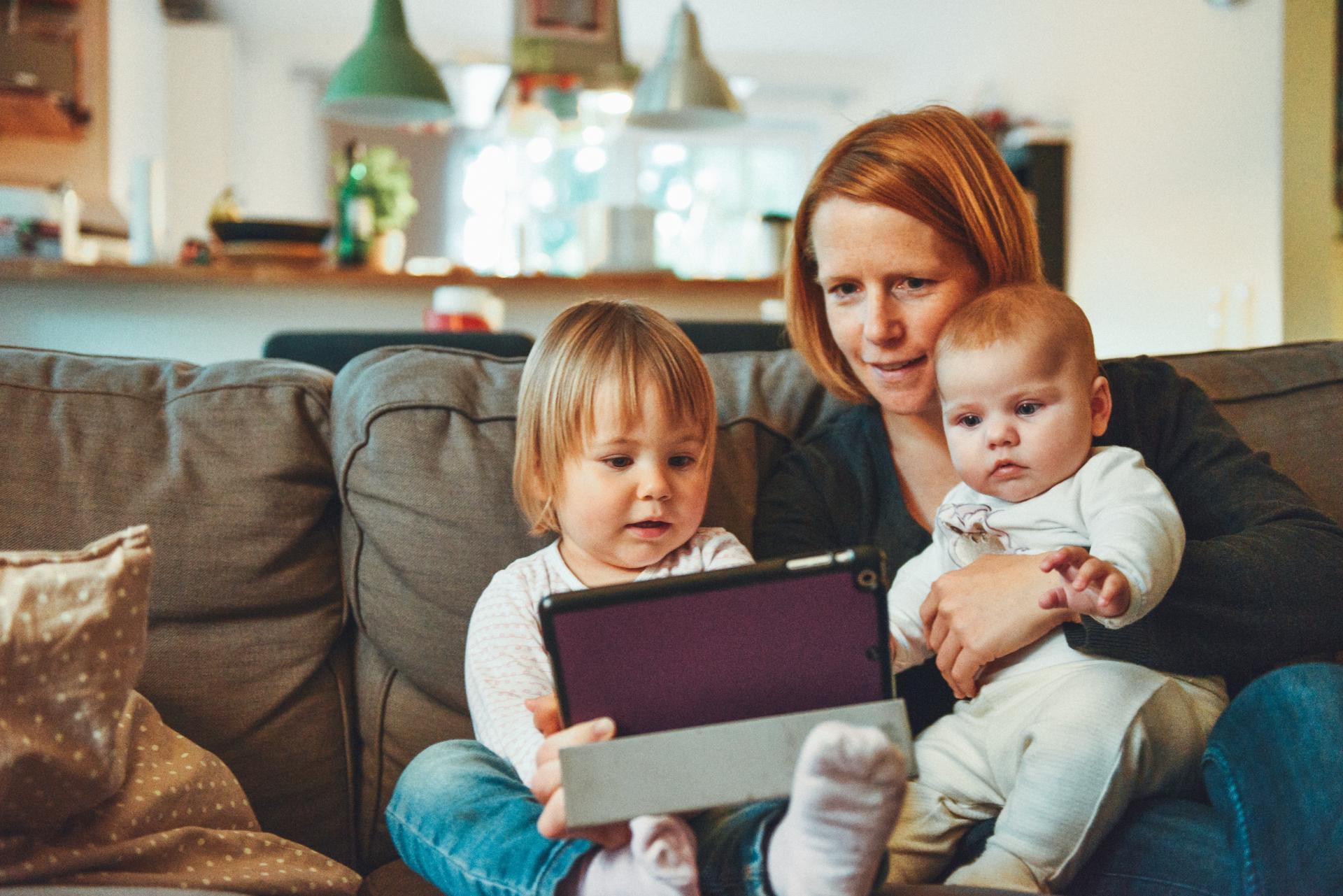 Child looking at screen with family 