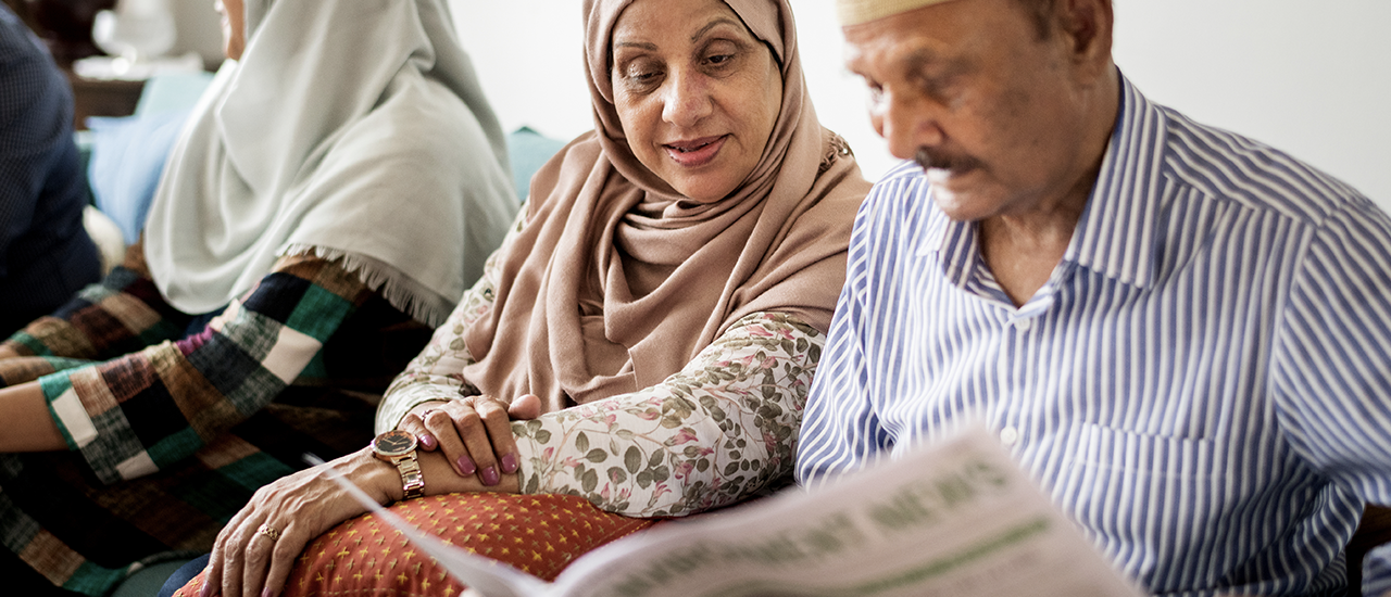 Husband wife reading newspaper